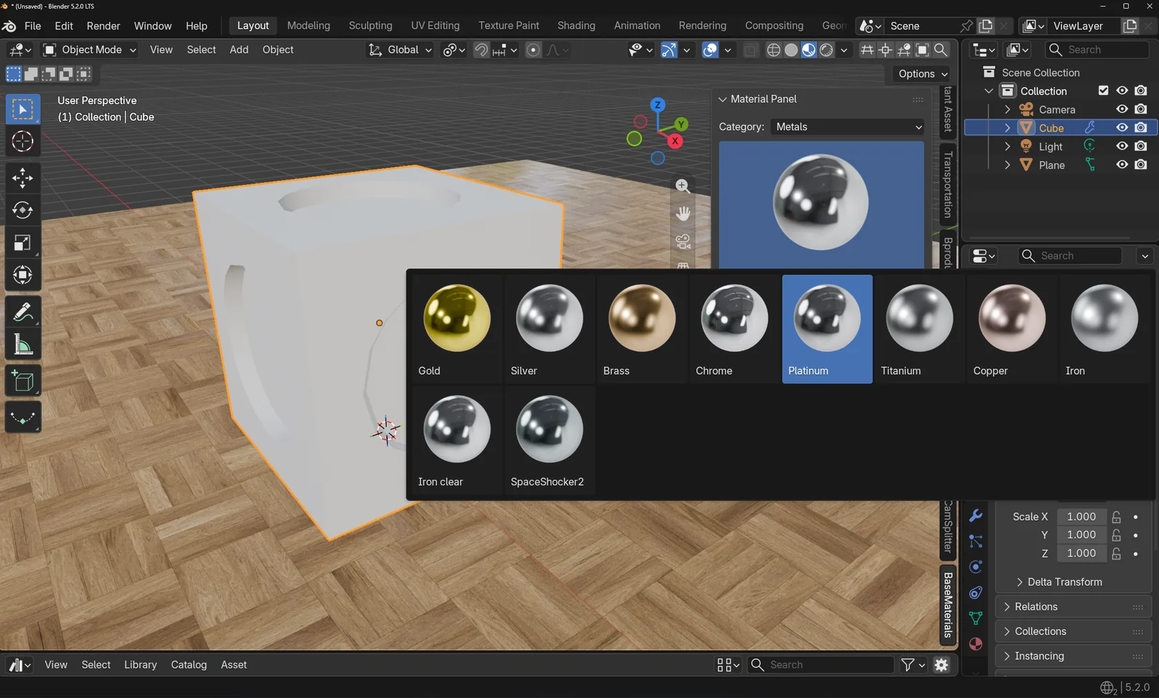 Blender-Viewport mit dem BaseMaterials-Panel: Kategorie „Metals“ und großes Vorschau-Dropdown mit Kugel-Previews für Gold, Silver, Brass, Chrome, Platinum, Titanium, Copper, Iron, Iron clear und SpaceShocker2